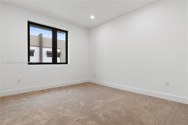 carpeted empty room with recessed lighting and baseboards