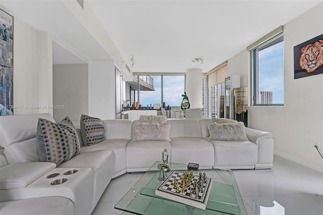 tiled living area featuring baseboards