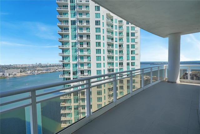 balcony featuring a view of city and a water view