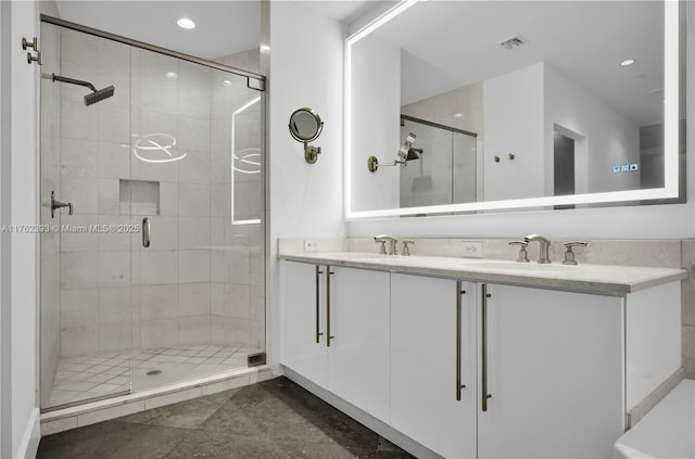 full bathroom with a shower stall, double vanity, visible vents, and a sink