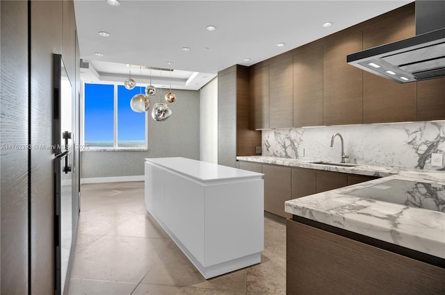 kitchen with a kitchen island, modern cabinets, wall chimney range hood, and a sink