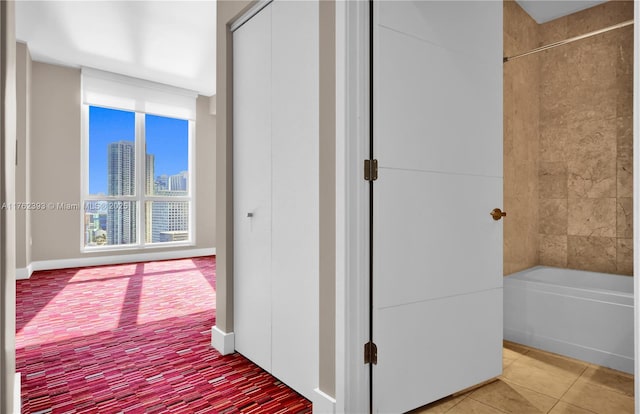 corridor with a view of city and light tile patterned floors