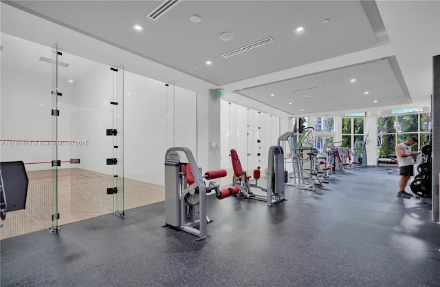 workout area featuring visible vents and floor to ceiling windows