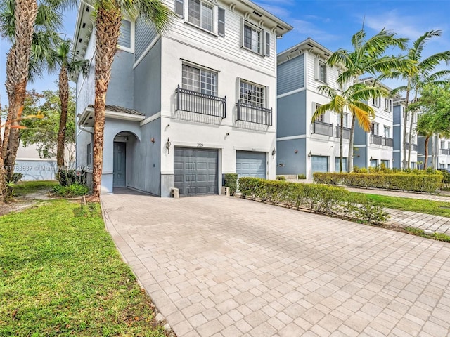 3525 NW 14th Ct, Lauderhill, FL 33311 - view of front of property featuring stucco siding, decorative driveway, and a garage