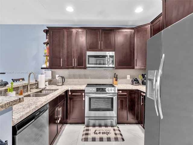 kitchen featuring a sink, stainless steel appliances, tasteful backsplash, and marble finish floor