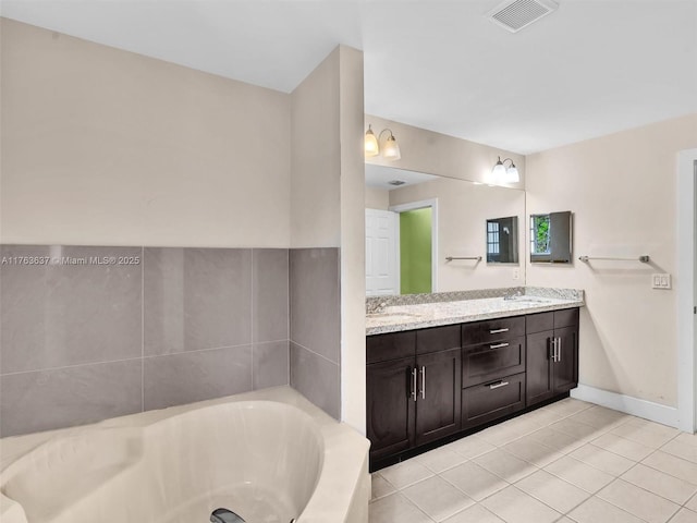 full bathroom featuring a bath, visible vents, tile patterned floors, and a sink