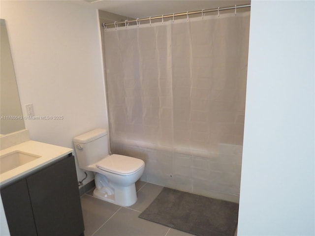 bathroom featuring tile patterned floors, toilet, vanity, and shower / tub combo with curtain