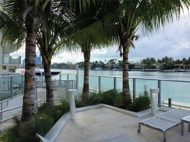 view of patio with a balcony and a water view