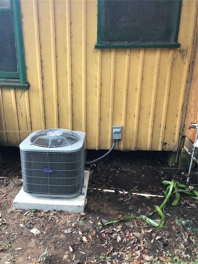 details featuring board and batten siding and central AC