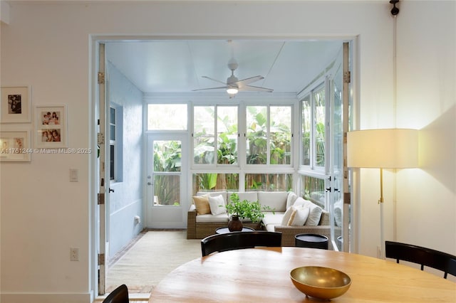 sunroom featuring a ceiling fan