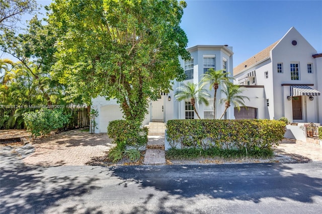 view of front facade featuring stucco siding and decorative driveway