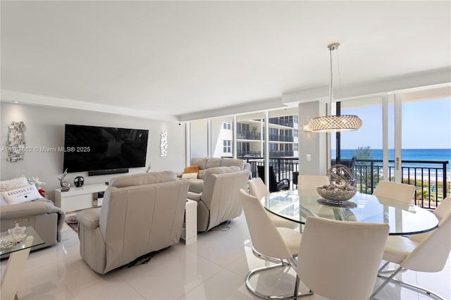 living room featuring a wall of windows and light tile patterned floors