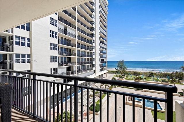 balcony featuring a beach view and a water view