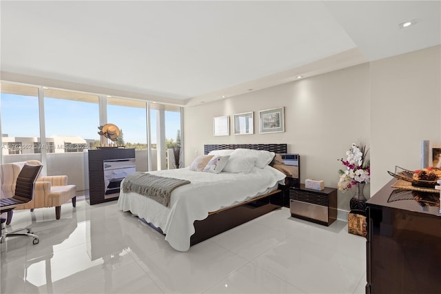 bedroom with access to exterior, floor to ceiling windows, and recessed lighting