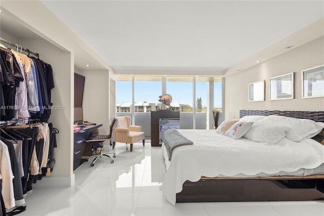 bedroom with tile patterned floors and floor to ceiling windows