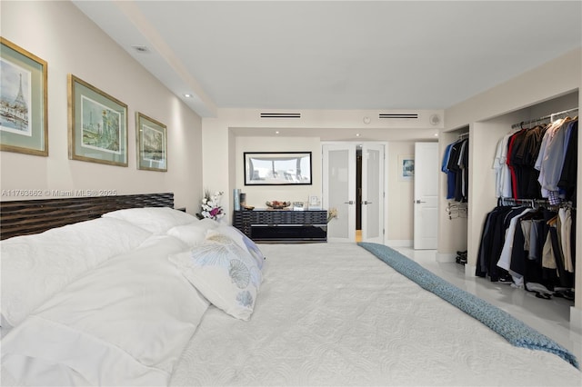 bedroom with a closet, visible vents, and recessed lighting