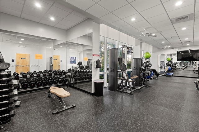 gym featuring visible vents, a ceiling fan, and a drop ceiling