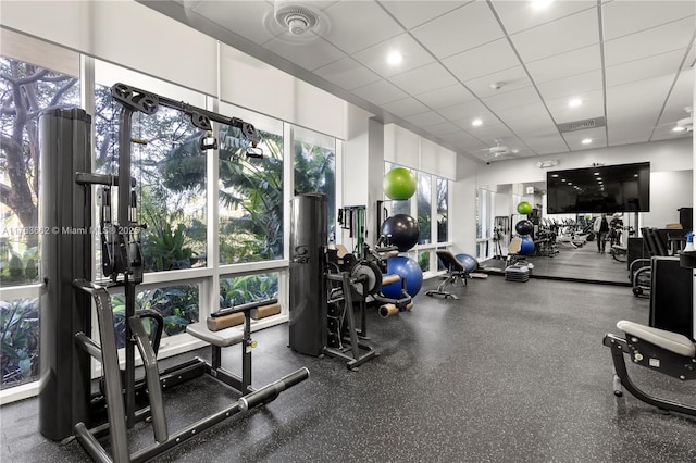 gym with a drop ceiling and visible vents