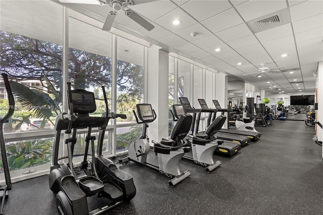 gym with a wall of windows, visible vents, plenty of natural light, and a ceiling fan