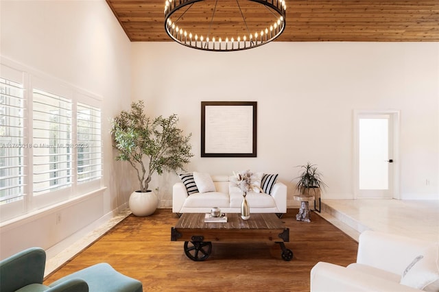 living room with baseboards, wooden ceiling, an inviting chandelier, wood finished floors, and high vaulted ceiling