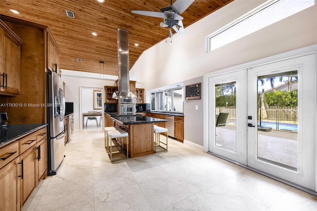 kitchen featuring a breakfast bar area, french doors, stainless steel appliances, and wooden ceiling