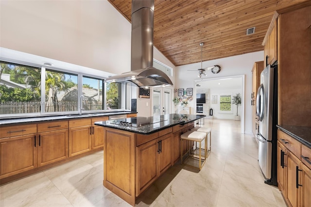 kitchen featuring island exhaust hood, a center island, freestanding refrigerator, wooden ceiling, and black electric stovetop