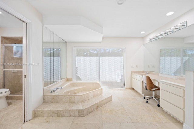 bathroom with vanity, recessed lighting, a tub with jets, and a stall shower