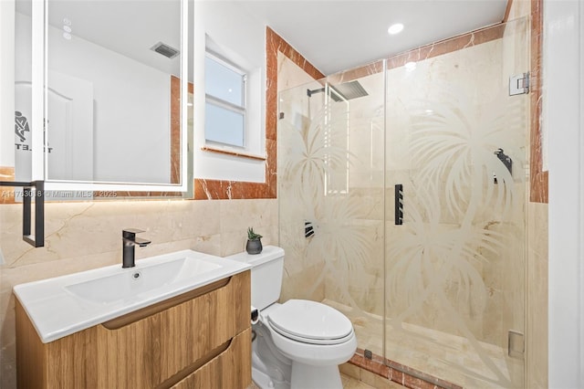 full bathroom featuring vanity, visible vents, a shower stall, tile walls, and toilet