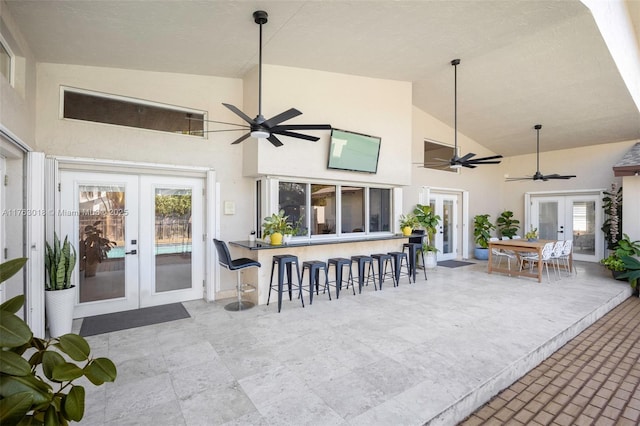 view of patio featuring outdoor dry bar, french doors, and ceiling fan