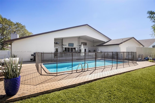 view of pool featuring a yard, a fenced in pool, a patio, and fence