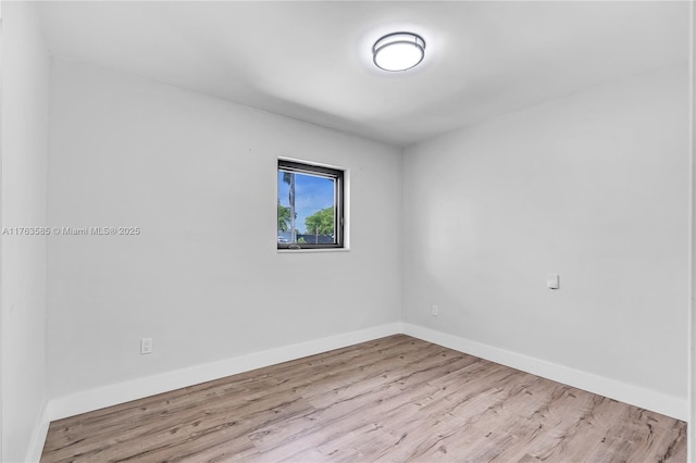 empty room with wood finished floors and baseboards