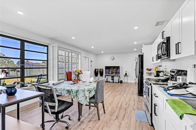 dining space featuring visible vents, recessed lighting, and light wood-style floors