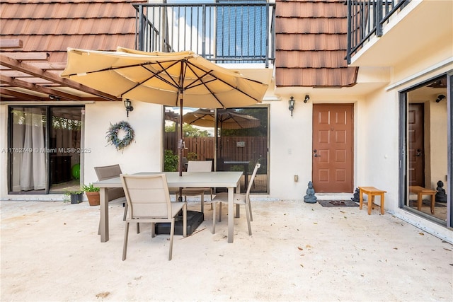 view of patio / terrace with outdoor dining space and a balcony