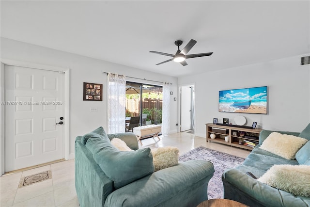 living area featuring light tile patterned floors, visible vents, baseboards, and a ceiling fan