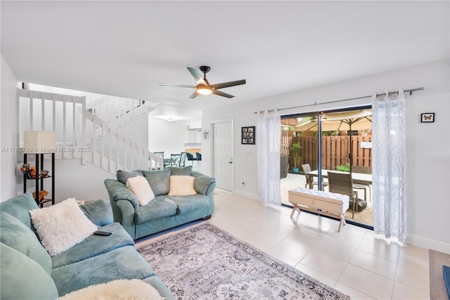 tiled living room with baseboards, stairs, and ceiling fan