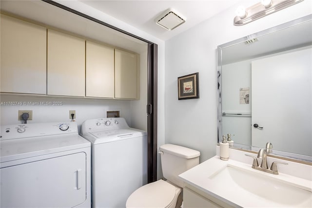 half bathroom featuring visible vents, independent washer and dryer, toilet, and vanity