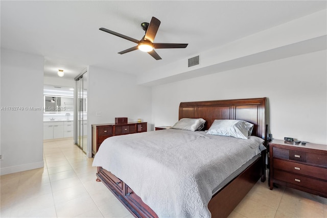 bedroom with visible vents, a sink, ensuite bath, light tile patterned floors, and ceiling fan