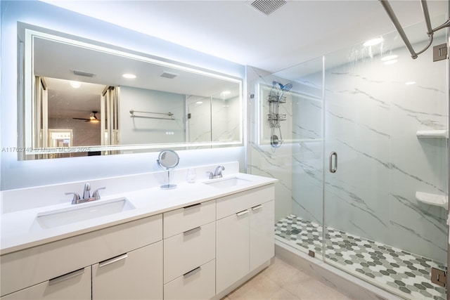 bathroom featuring double vanity, visible vents, a marble finish shower, and a sink