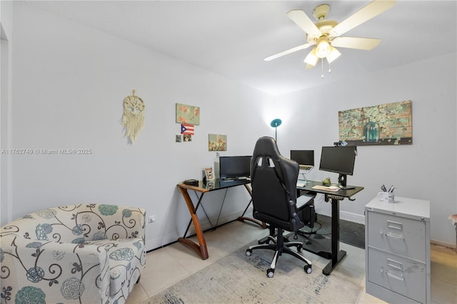 office featuring light tile patterned floors, baseboards, and ceiling fan