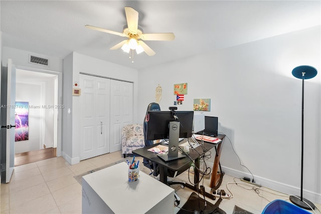 office area with light tile patterned floors, visible vents, baseboards, and ceiling fan