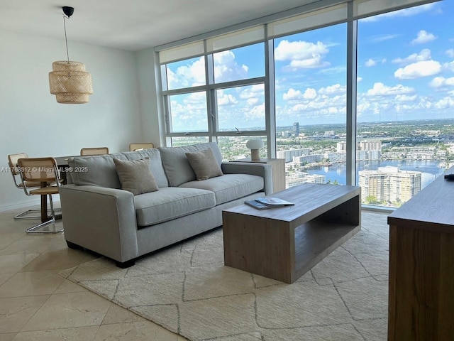 living room with a wall of windows, plenty of natural light, and a water view