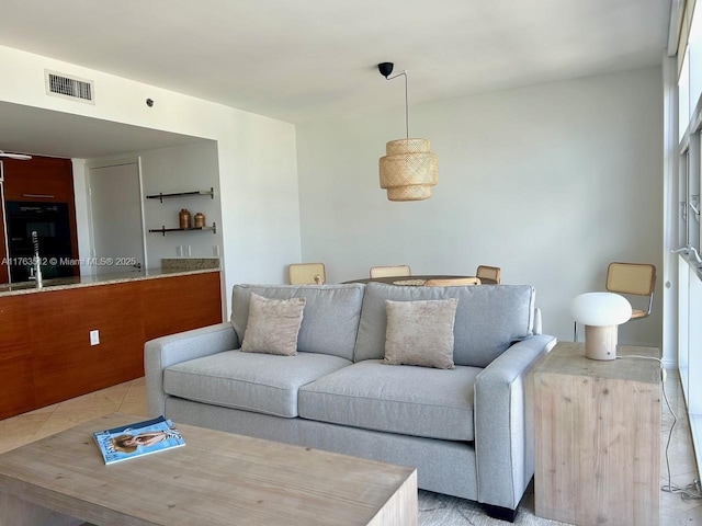 living room with visible vents and tile patterned flooring