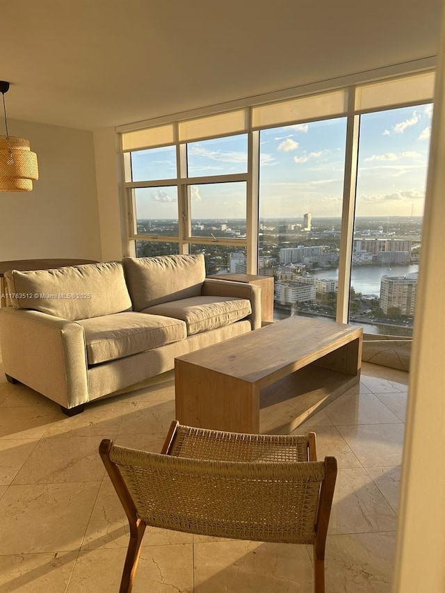 living room with a city view, a wall of windows, plenty of natural light, and a water view