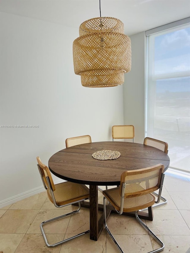 dining space featuring baseboards