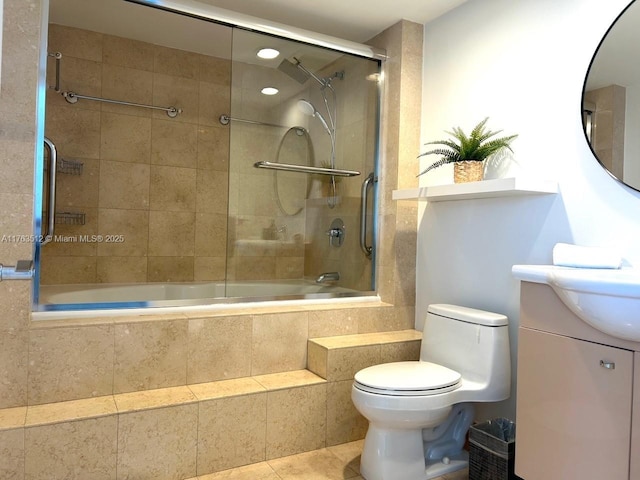 full bathroom with vanity, tile patterned floors, toilet, and tiled shower / bath combo