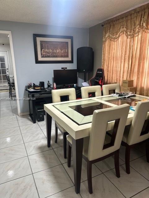 dining room with a textured ceiling