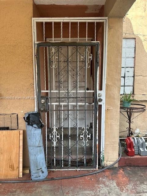 doorway to property featuring stucco siding