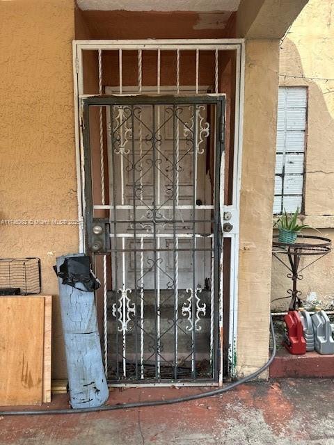2162 NW 26th St, Miami, FL 33142 - property entrance featuring stucco siding