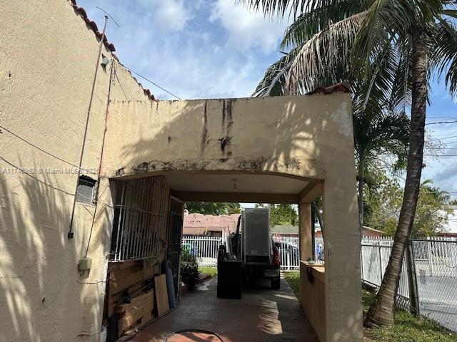 2162 NW 26th St, Miami, FL 33142 - view of vehicle parking with a carport and fence
