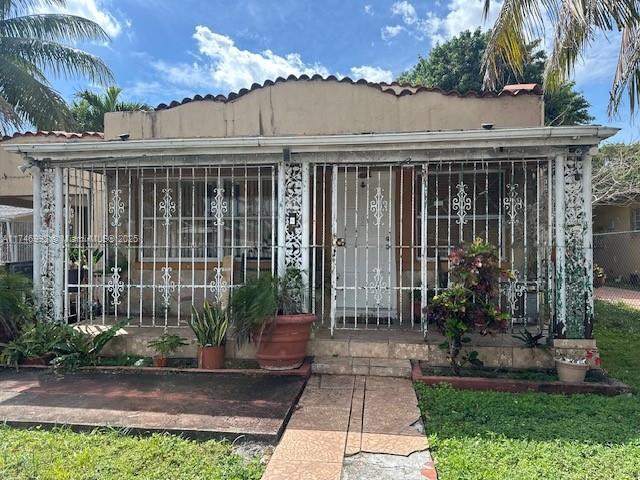 doorway to property featuring fence